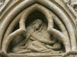 Panel 12:06 - Crouching hooded figure hiding money-bag (miser?)